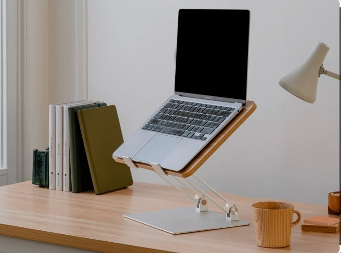 Minimalist home office desk with laptop stand and white desk lamp — best home office desk 2025